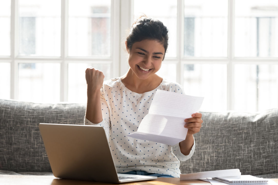 woman happily reading letter