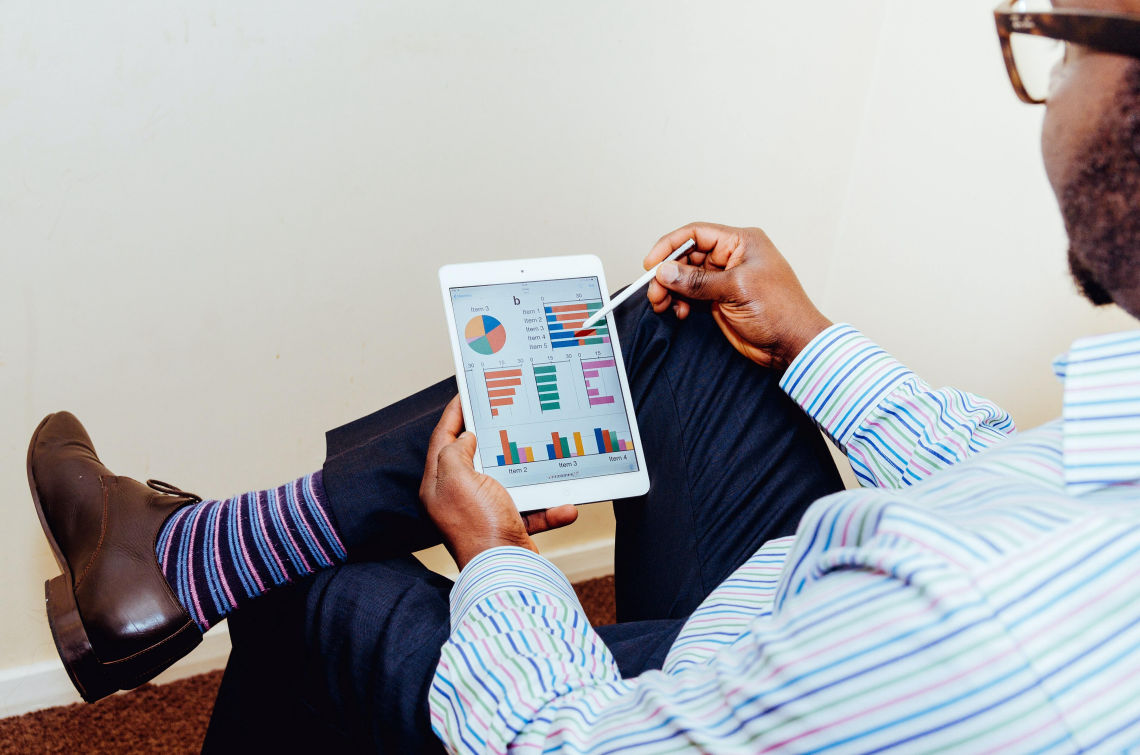 Man viewing charts on a tablet